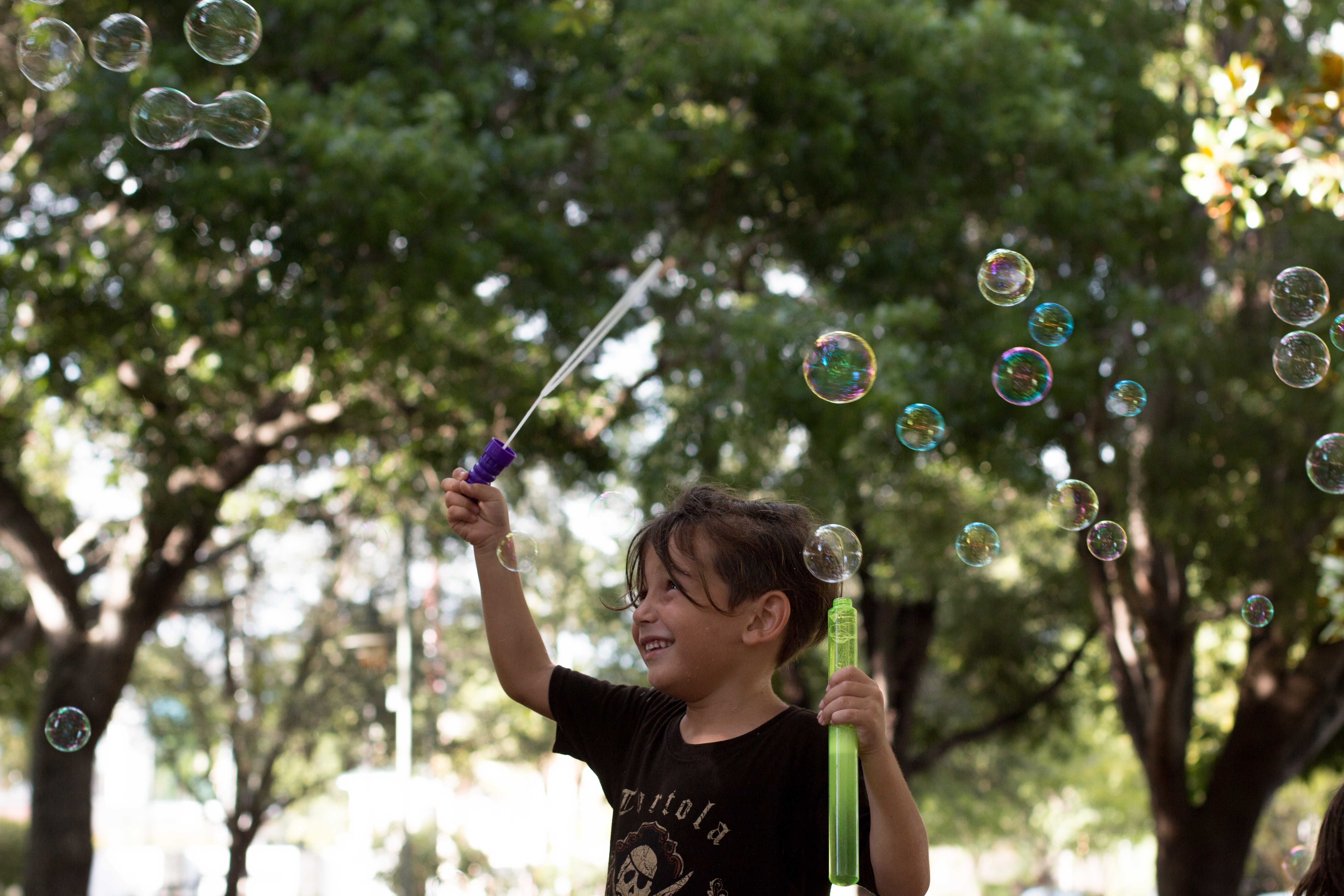 A boy plays with bubbles in Cambier Park in Naples, FL